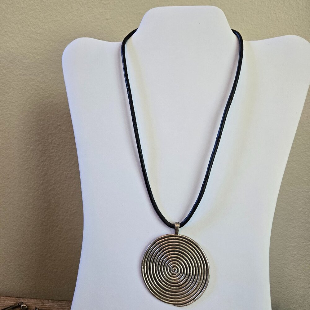 Antique silver pendant on leather cord